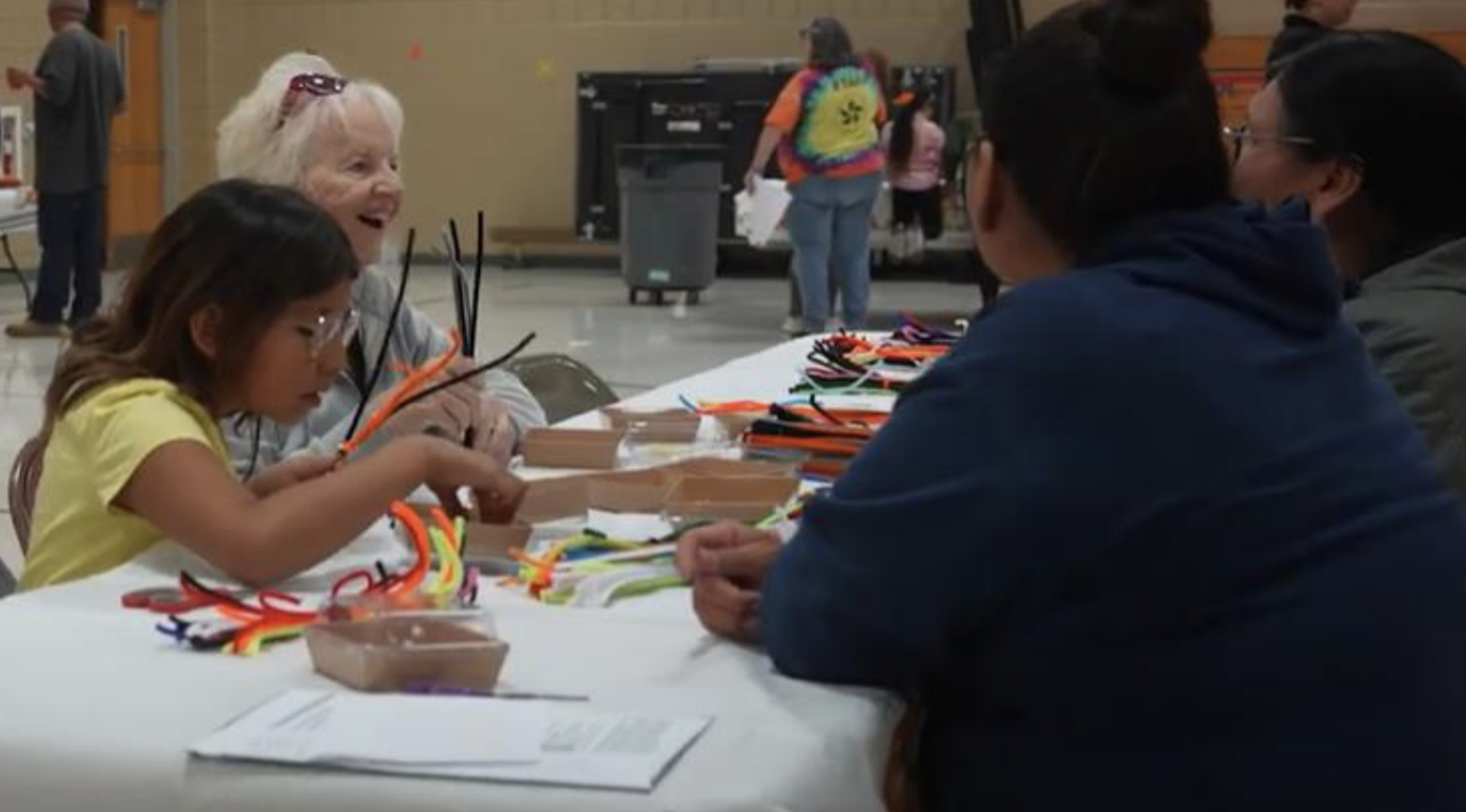 A family sits at a table working on an art project during family night at a Sioux Falls Community Learning Center. 