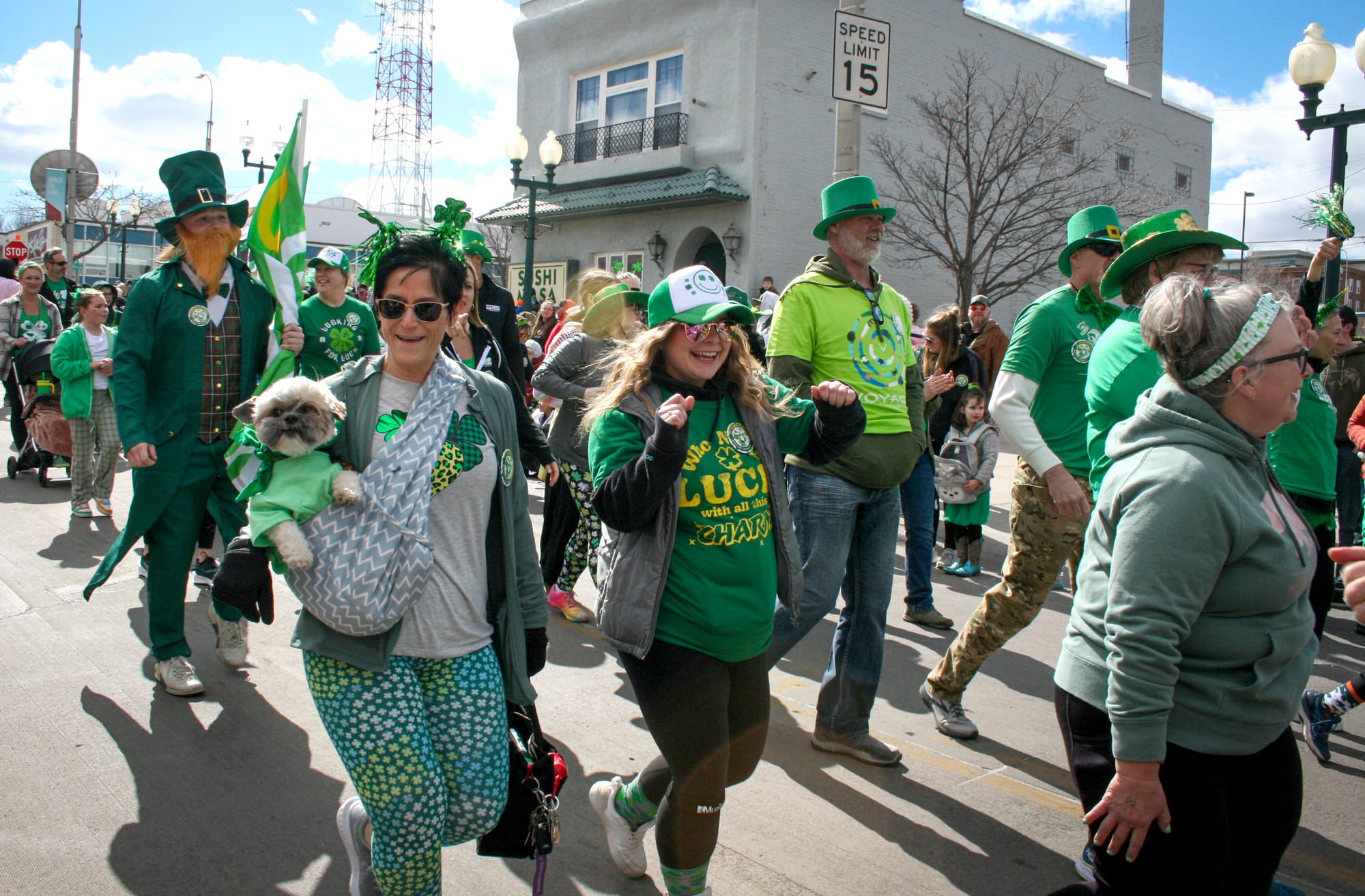 People dressed in green walk in the St. Patrick's Day parade in downtown Sioux Falls. 